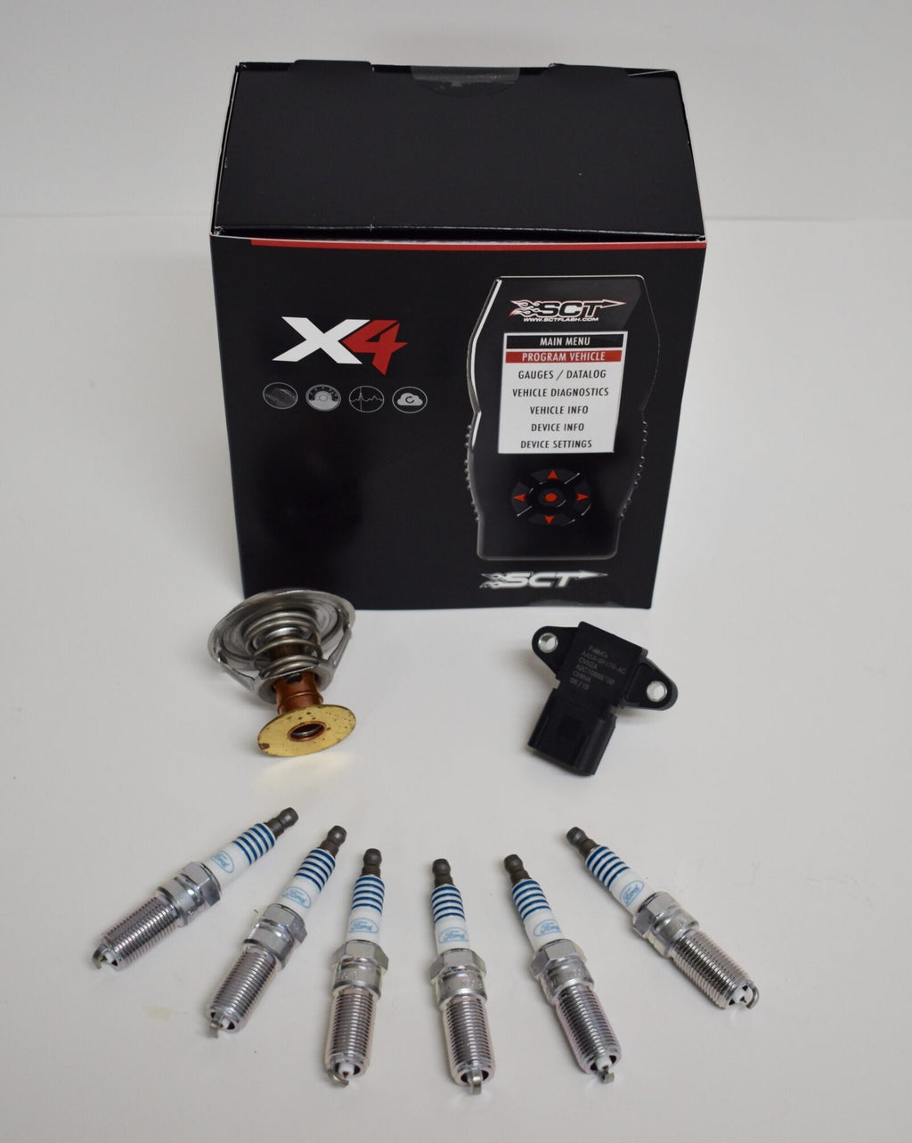 A box with some different types of spark plugs