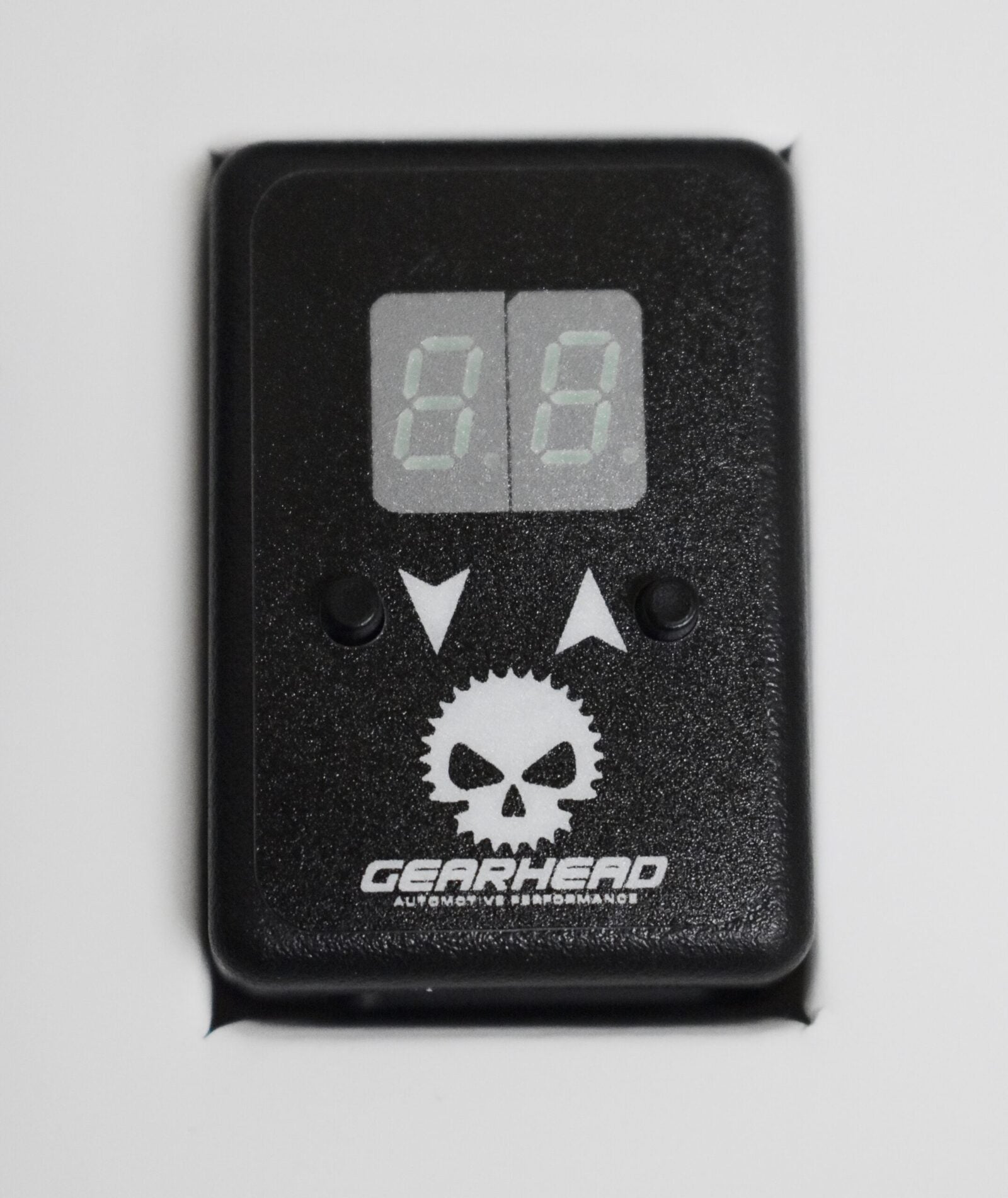 A black device with a skull and two small spikes.