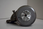 A close up of the side of an old style coffee grinder.