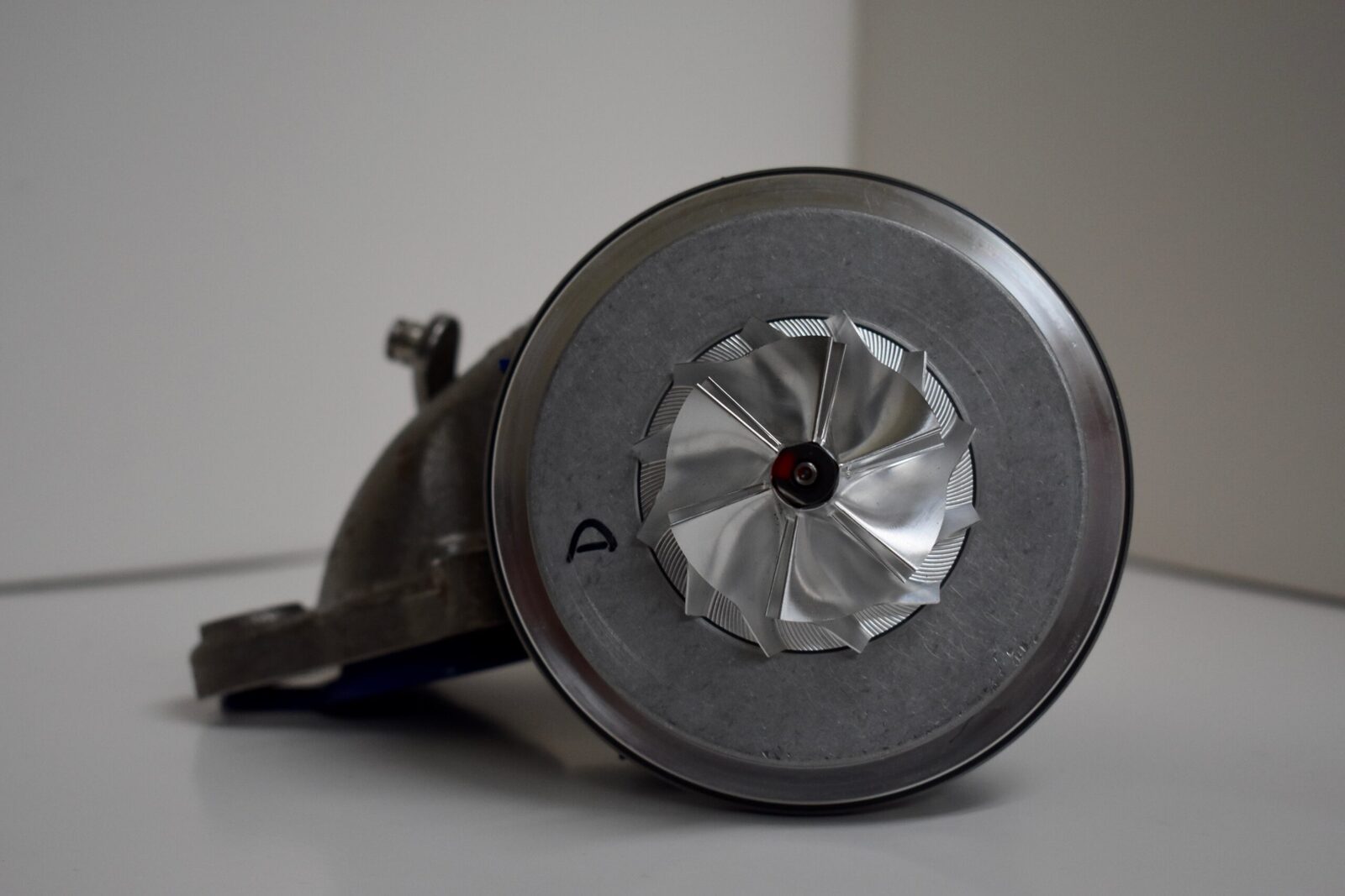 A close up of the side of an old style coffee grinder.