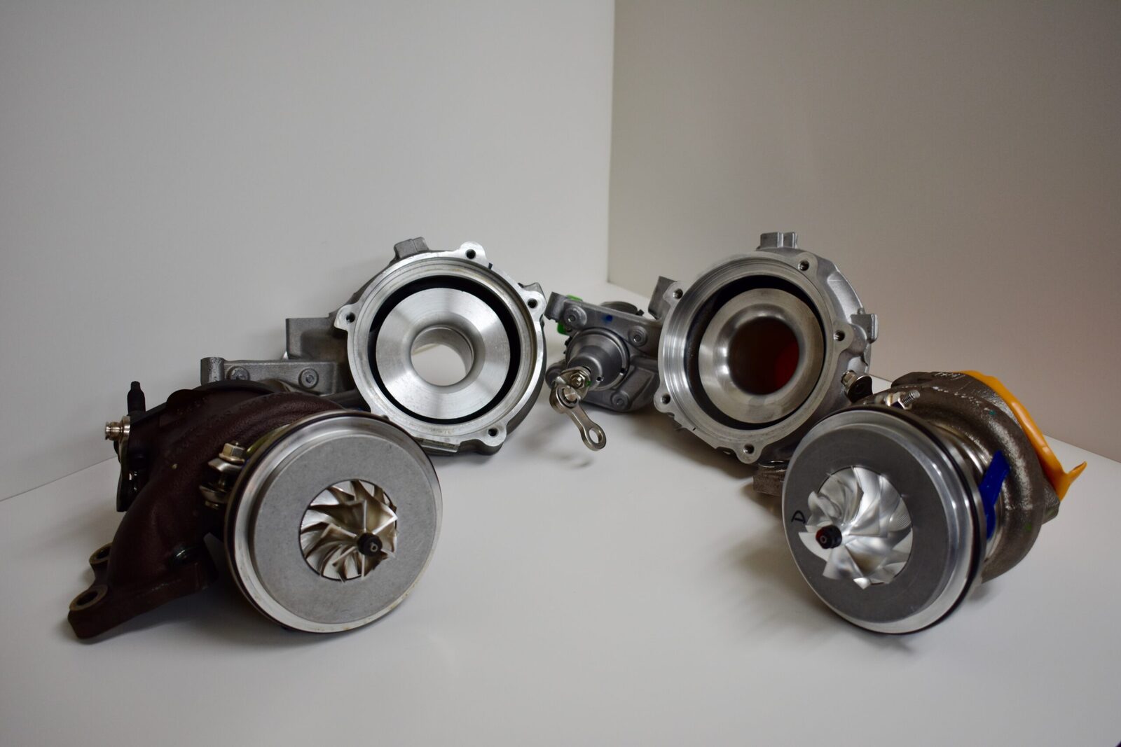 A group of four different types of metal parts.