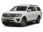 A white suv is parked in front of the camera.