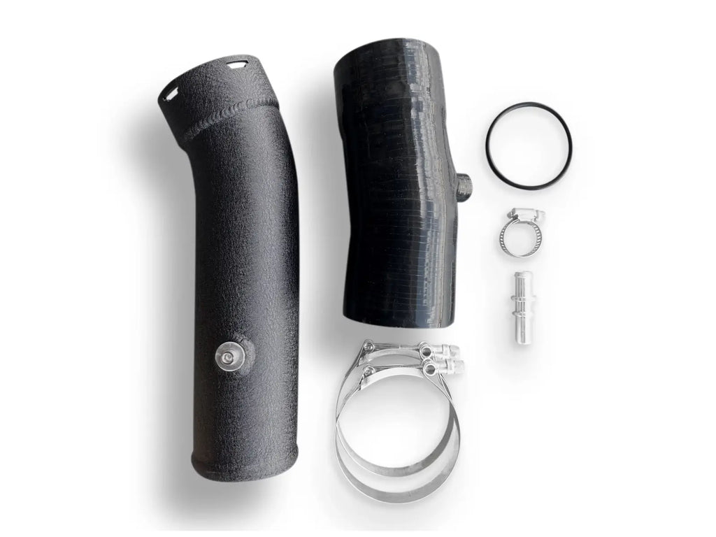 A black pipe and its parts are laying on the ground.