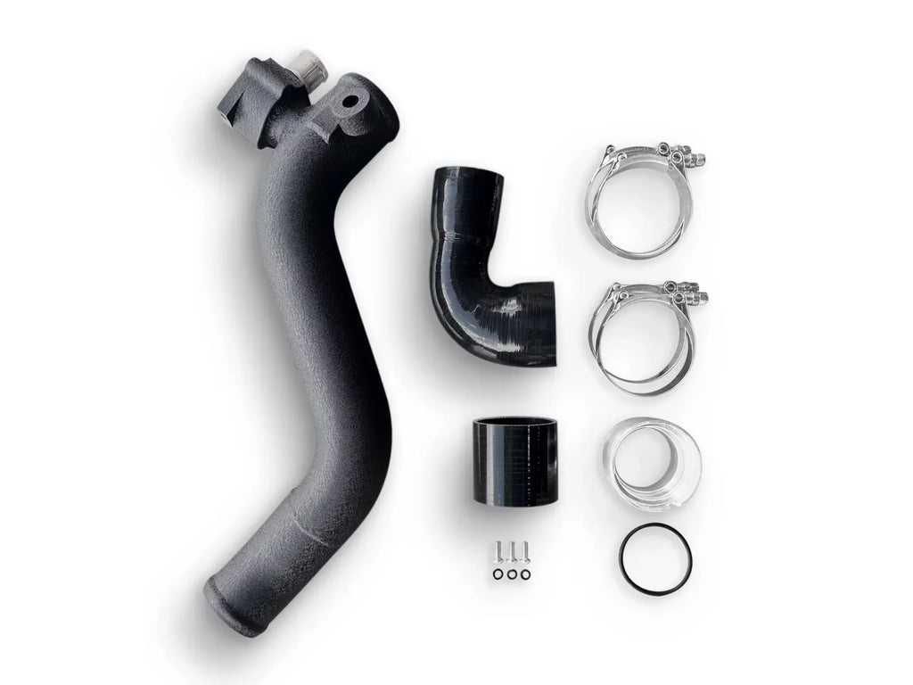 A black hose and its parts are laying on the ground.