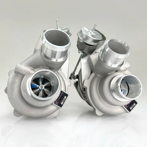 A pair of turbochargers are shown on the table.